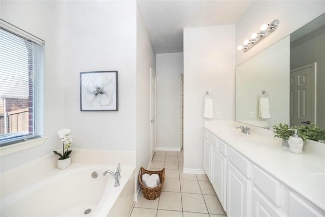 bathroom featuring vanity, tile patterned flooring, and a tub