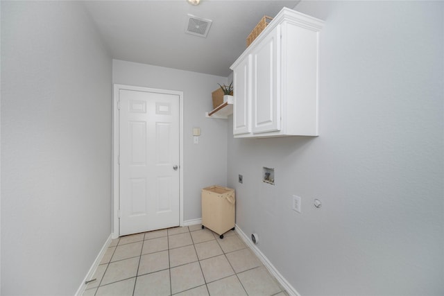 washroom featuring light tile patterned flooring, cabinets, hookup for a gas dryer, hookup for a washing machine, and electric dryer hookup