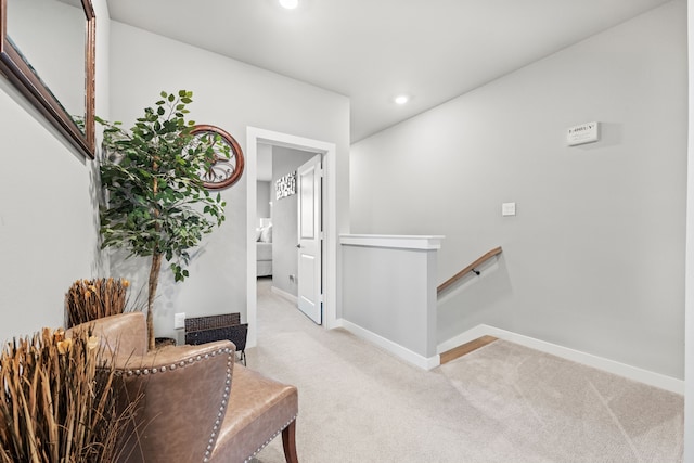 corridor featuring light colored carpet