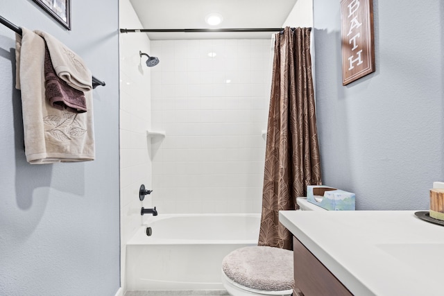 full bathroom with vanity, shower / tub combo, and toilet