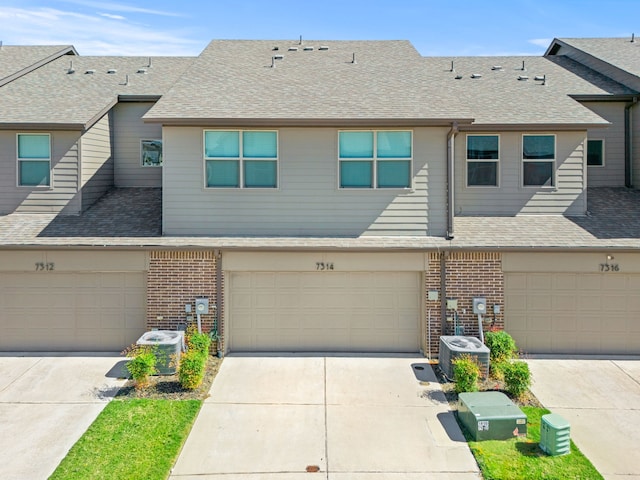 view of property with central AC and a garage