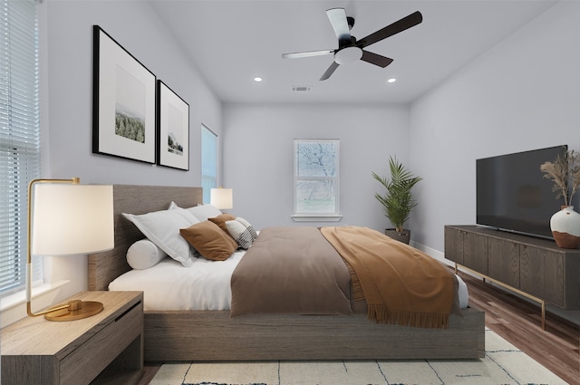 bedroom featuring multiple windows, ceiling fan, and light wood-type flooring