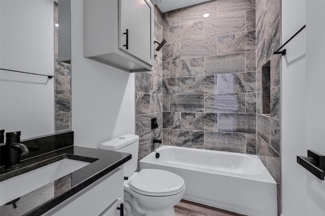 full bathroom featuring vanity, toilet, and tiled shower / bath