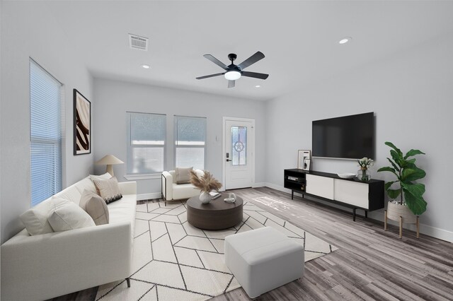 living room with ceiling fan and light hardwood / wood-style floors