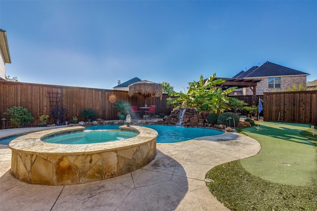 view of pool with an in ground hot tub, pool water feature, and a patio