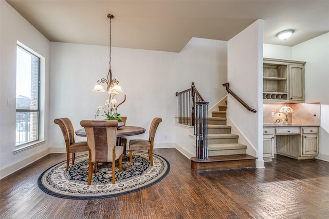 dining area featuring dark hardwood / wood-style flooring, an inviting chandelier, and a healthy amount of sunlight