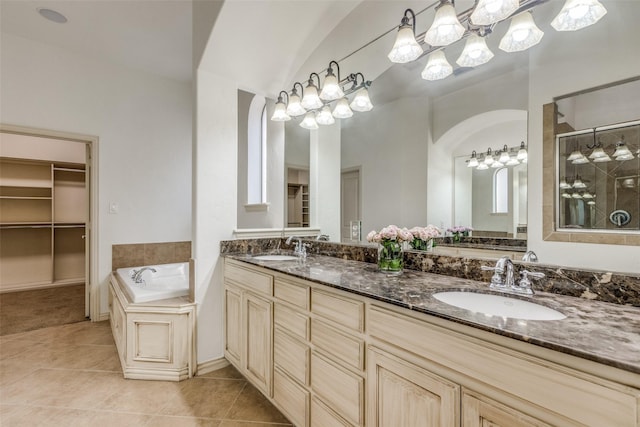 bathroom with plus walk in shower, a notable chandelier, tile patterned floors, lofted ceiling, and vanity