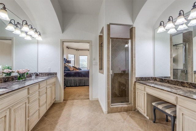 bathroom with tile patterned floors, vanity, and an enclosed shower