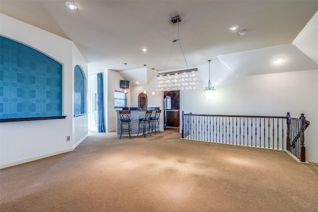 interior space with indoor bar and vaulted ceiling