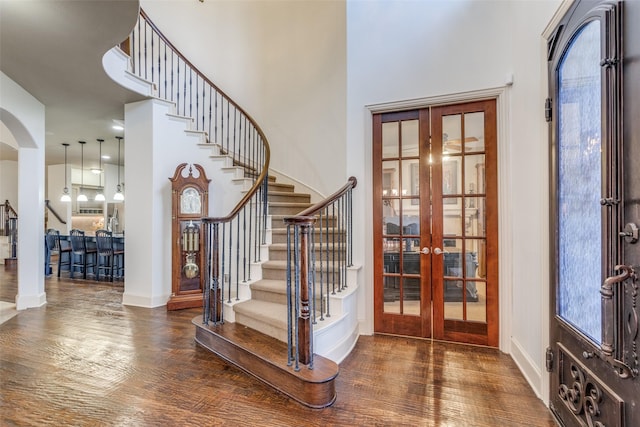 foyer featuring dark hardwood / wood-style flooring, french doors, and a high ceiling