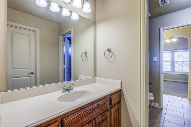 bathroom featuring tile patterned floors, vanity, and toilet