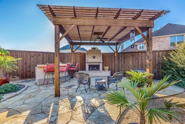 view of patio / terrace with ceiling fan, a pergola, and exterior fireplace