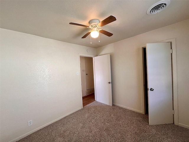 carpeted spare room with ceiling fan