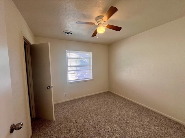 unfurnished room featuring ceiling fan, carpet floors, and a textured ceiling