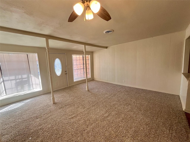 entrance foyer featuring ceiling fan and carpet