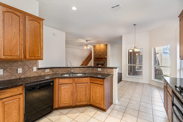 kitchen featuring sink, dark stone countertops, black dishwasher, decorative backsplash, and decorative light fixtures