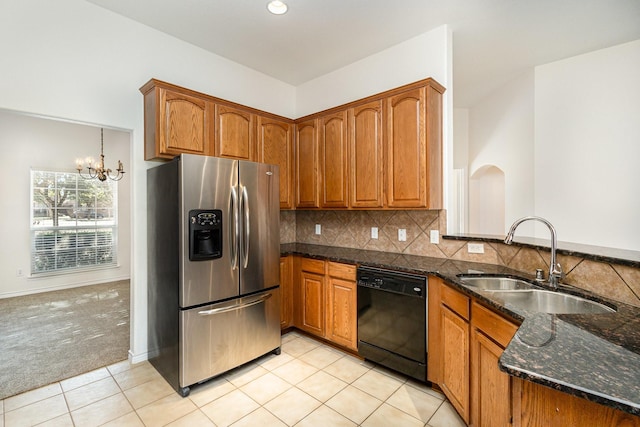 kitchen featuring sink, stainless steel fridge with ice dispenser, light carpet, dishwasher, and dark stone counters