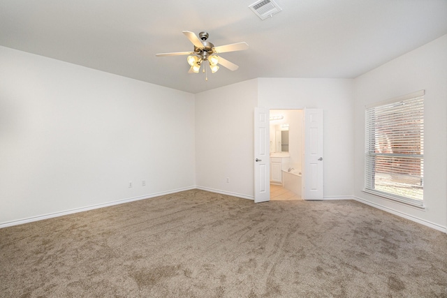 spare room featuring light colored carpet and ceiling fan