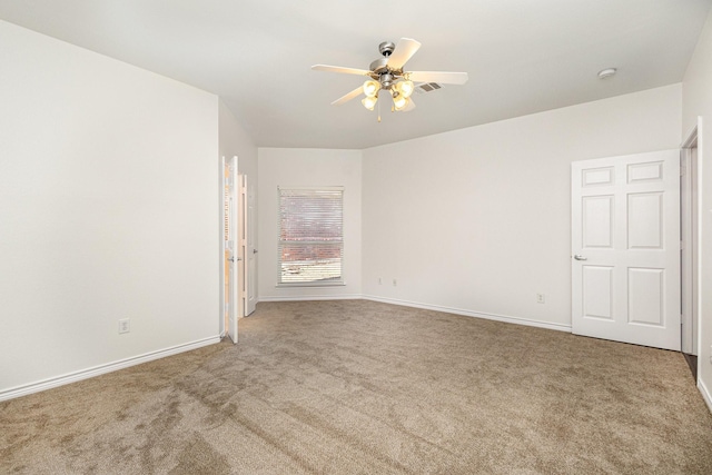 empty room featuring carpet floors and ceiling fan