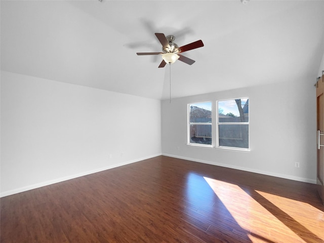 unfurnished room featuring dark wood-type flooring, ceiling fan, and vaulted ceiling