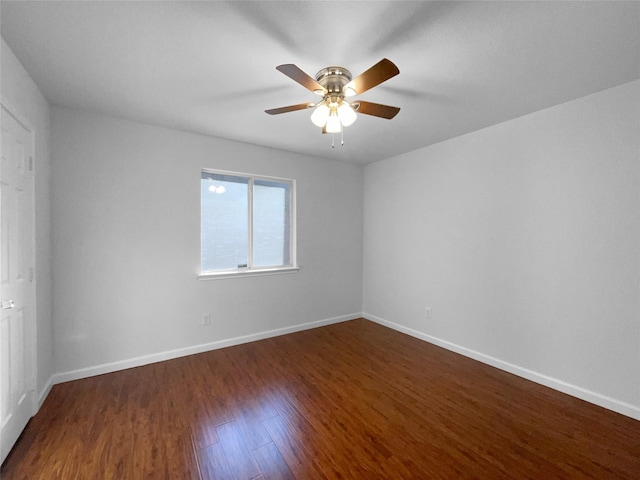 spare room with ceiling fan and dark hardwood / wood-style flooring