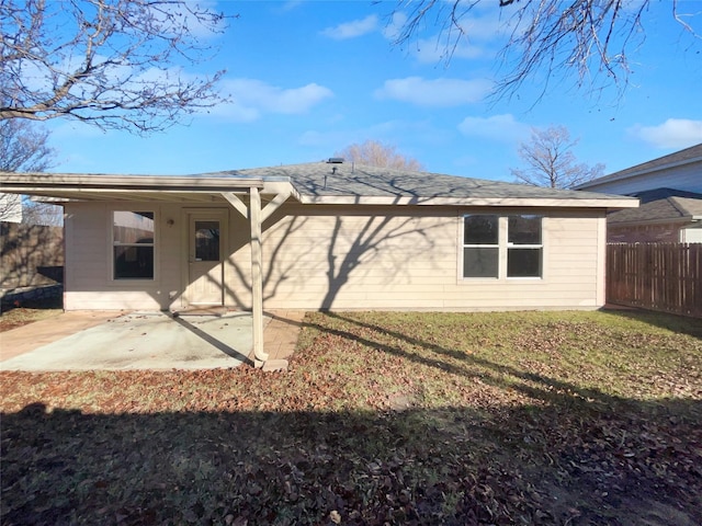 back of property featuring a lawn and a patio