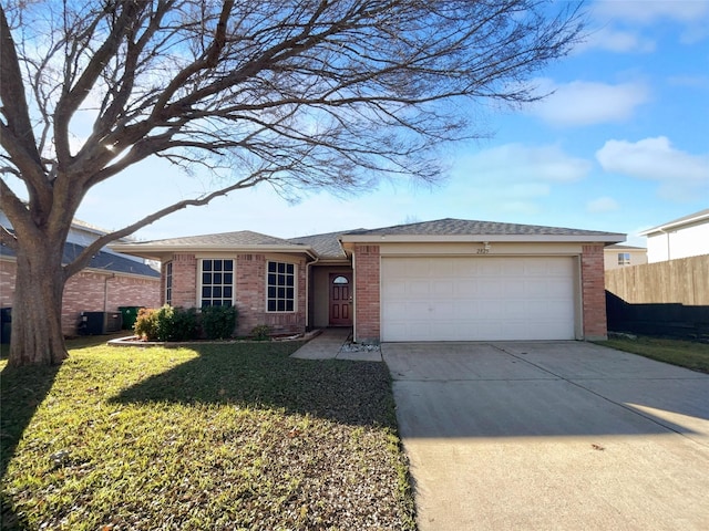 ranch-style home featuring a garage and a front yard