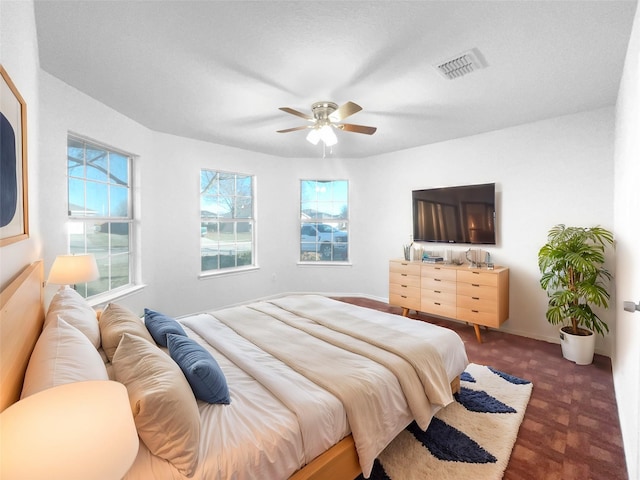 bedroom with multiple windows and ceiling fan