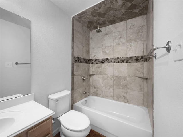 full bathroom featuring vanity, toilet, and tiled shower / bath combo