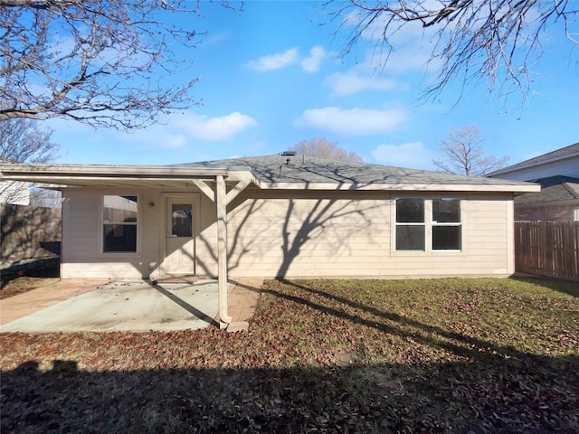 rear view of house with a yard and a patio