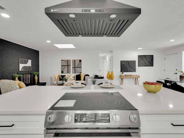 kitchen featuring white cabinetry, extractor fan, and electric range