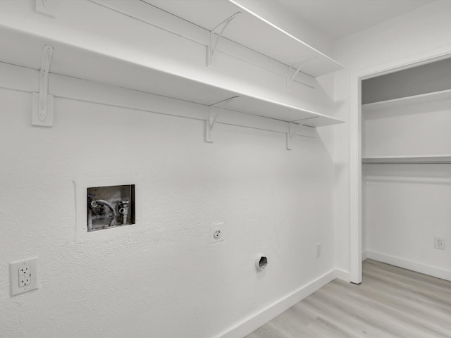 laundry area with washer hookup and light hardwood / wood-style flooring