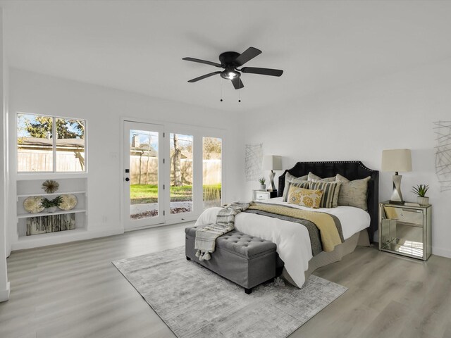 bedroom featuring ceiling fan, light wood-type flooring, and access to outside