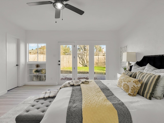 bedroom featuring ceiling fan, access to exterior, and light hardwood / wood-style floors