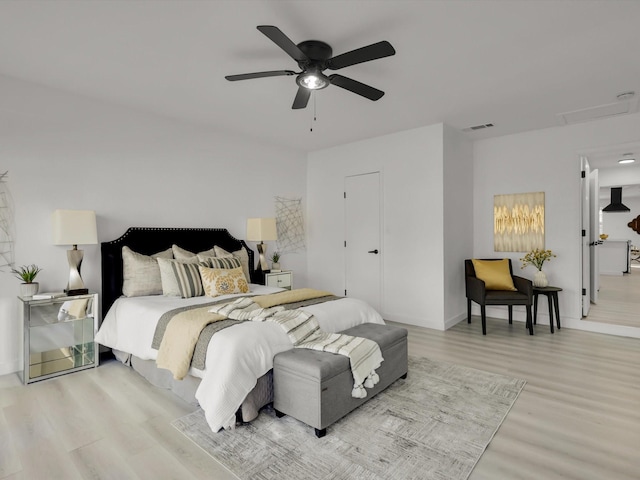 bedroom with light hardwood / wood-style floors and ceiling fan