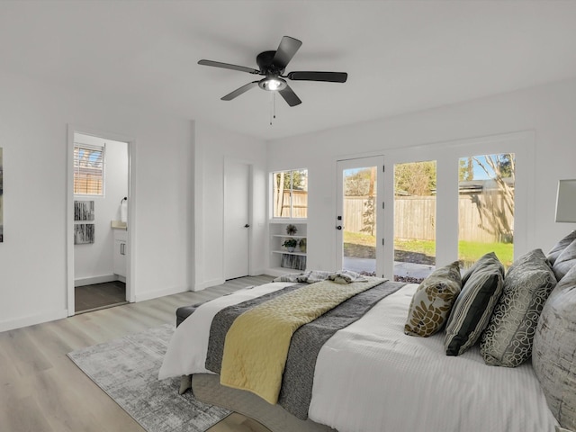 bedroom featuring ceiling fan, access to exterior, light hardwood / wood-style floors, and ensuite bath