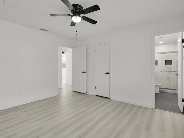 unfurnished bedroom featuring ceiling fan, connected bathroom, and light wood-type flooring