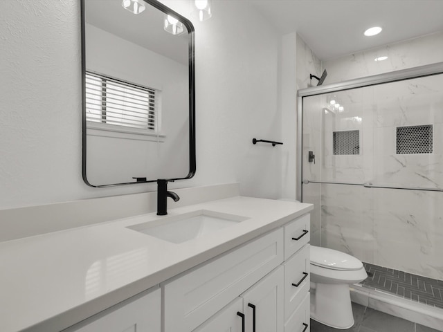 bathroom with walk in shower, vanity, and toilet