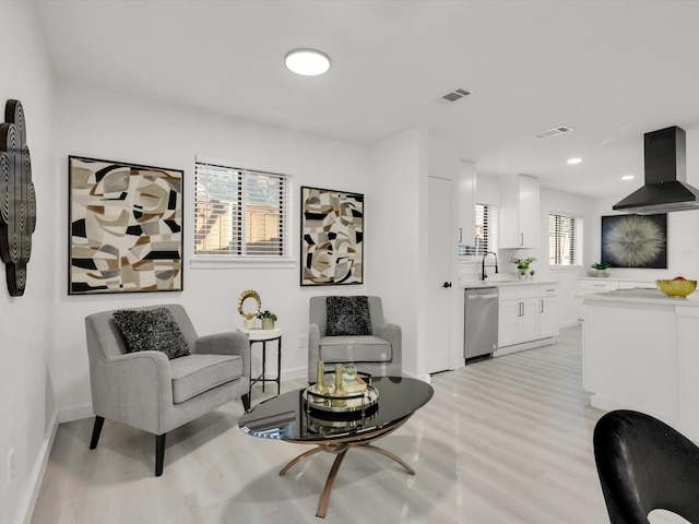 living room featuring sink and light wood-type flooring