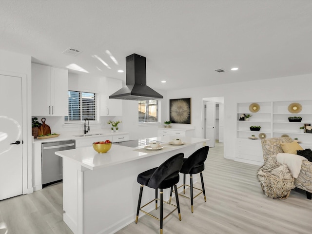 kitchen featuring a kitchen island, sink, island exhaust hood, stainless steel dishwasher, and cooktop