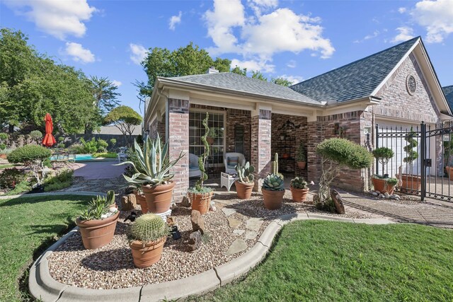 rear view of property with a lawn and a garage