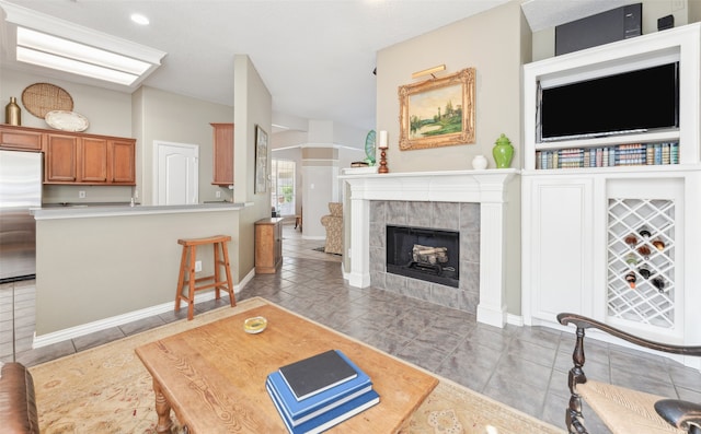 tiled living room featuring a tiled fireplace