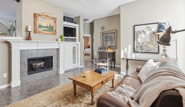 living room with tile patterned floors, built in features, and a tiled fireplace