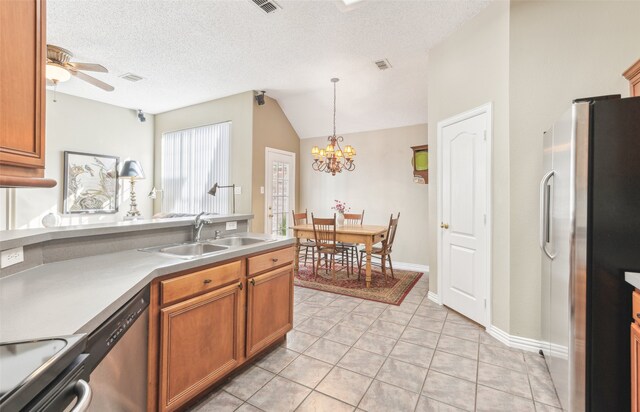 kitchen featuring sink, a textured ceiling, decorative light fixtures, ceiling fan with notable chandelier, and appliances with stainless steel finishes