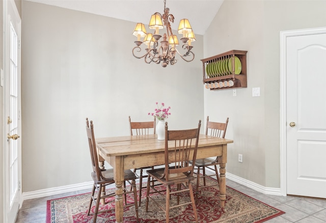 dining room with tile patterned floors and a notable chandelier