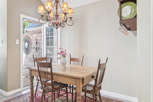 dining room featuring tile patterned flooring, a chandelier, and vaulted ceiling