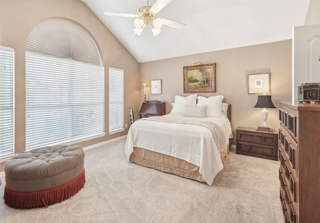 bedroom with ceiling fan, light carpet, and vaulted ceiling