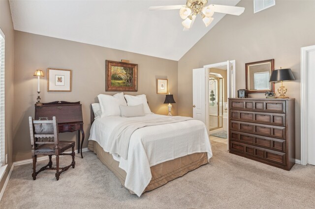 carpeted bedroom with ceiling fan, ensuite bathroom, and high vaulted ceiling