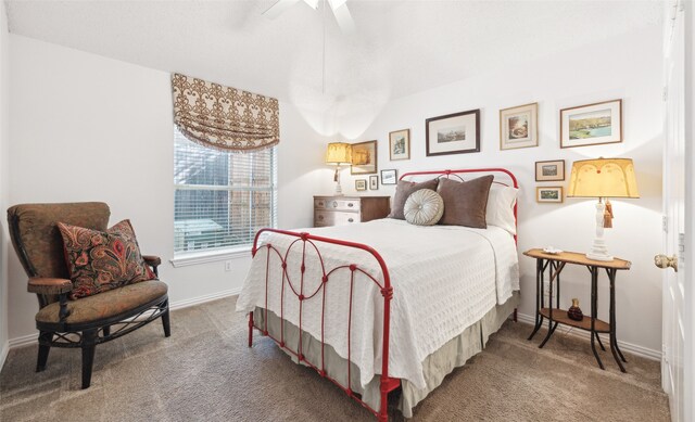 bedroom featuring ceiling fan and carpet