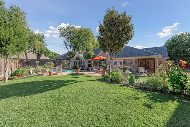 view of yard with a fenced in pool and a patio